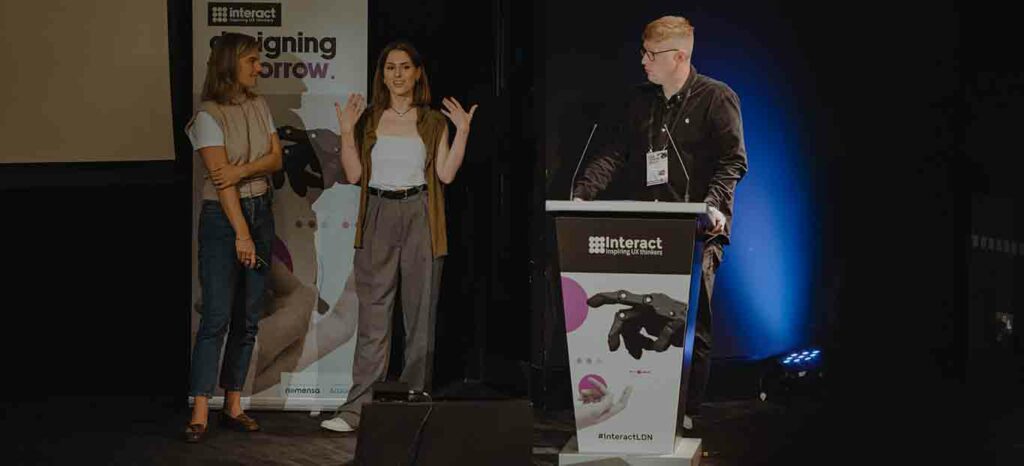 Interact London host speaks with Google speakers onstage at the event